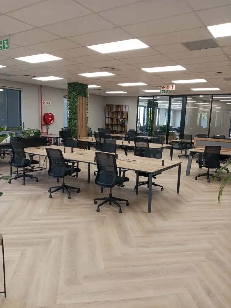 Completed open plan office interior with desks and chairs